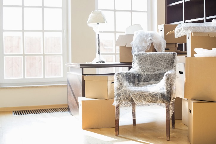 a living room with a chair and a lamp