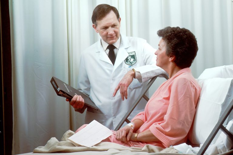 a doctor checking a patient's blood pressure