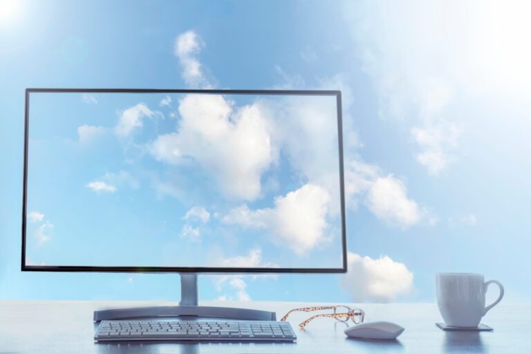 Computer monitor displaying clouds, illustrating cloud computing concept and technology trends.