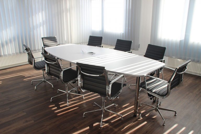 a large white table with chairs around it