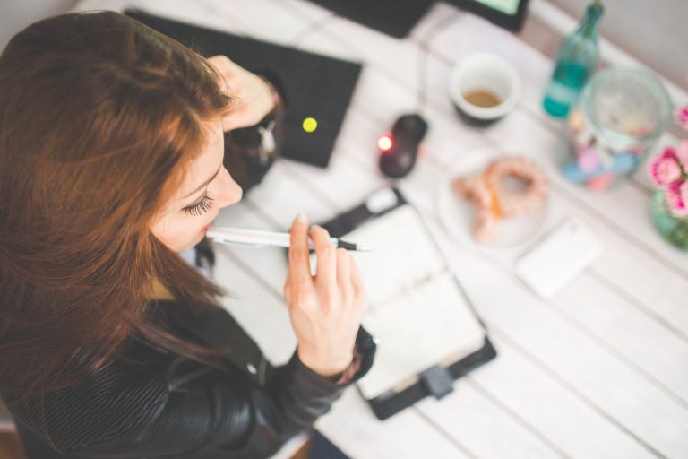 a woman looking at a piece of food