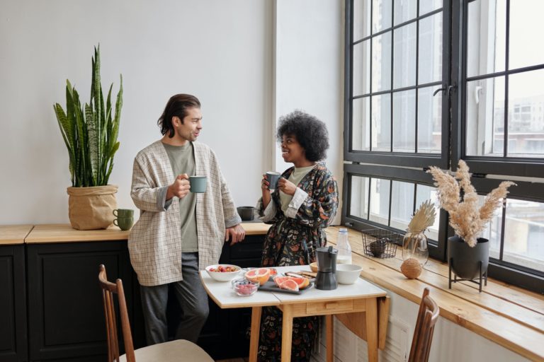 a person and a child eating in a kitchen