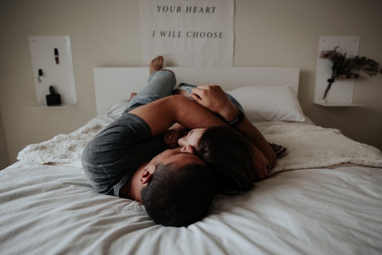 a man and woman lying in bed
