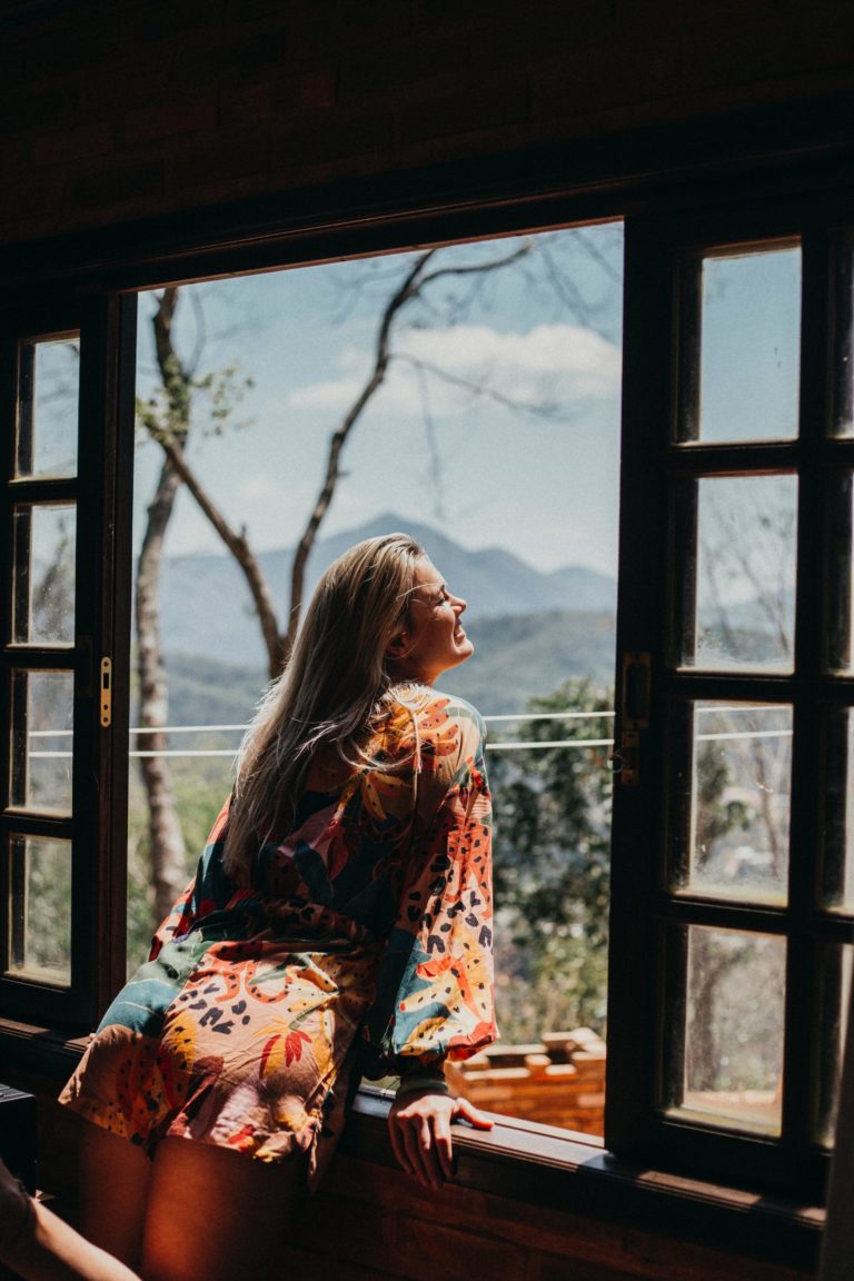 a woman sitting in a window