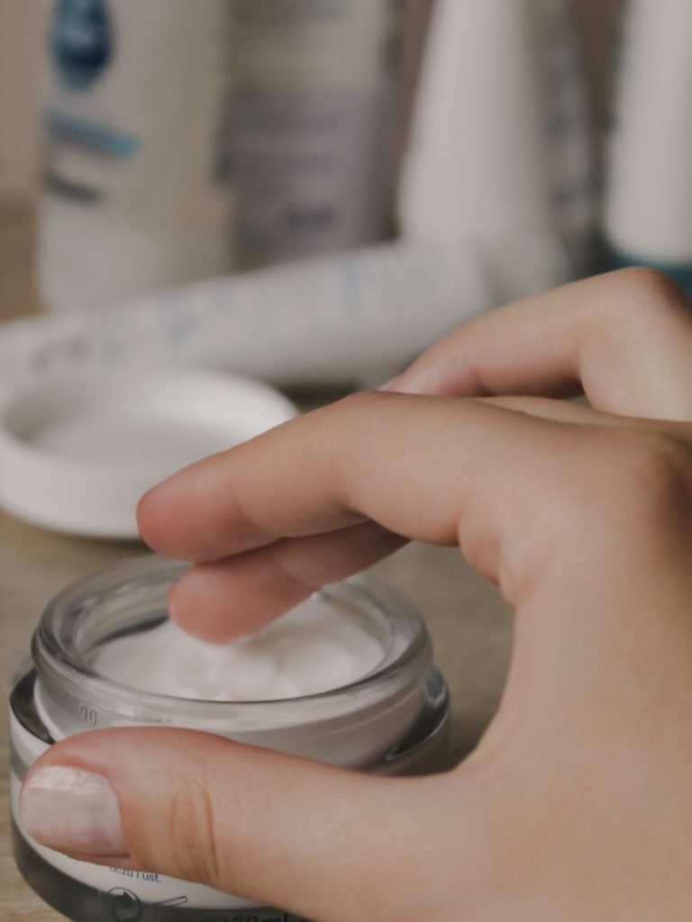 a hand holding a silver object