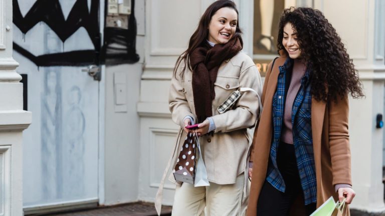 a couple of women walking down a hallway