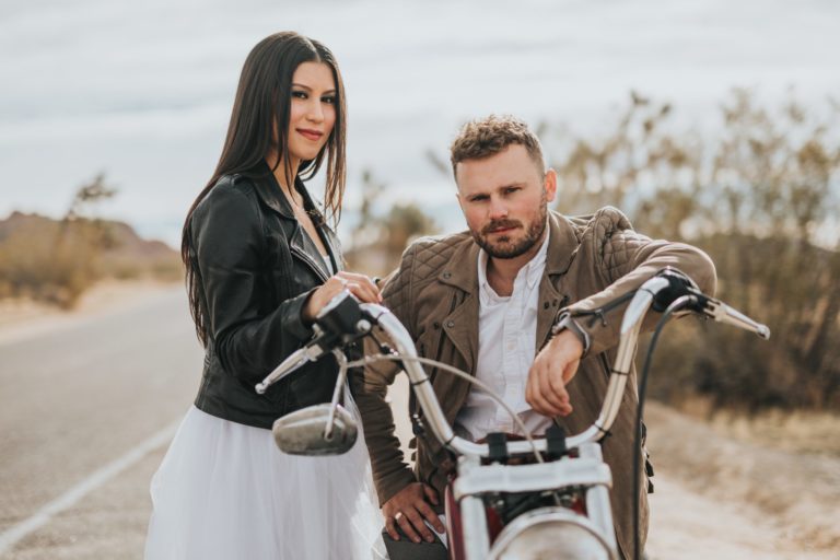 a man and woman on a motorcycle