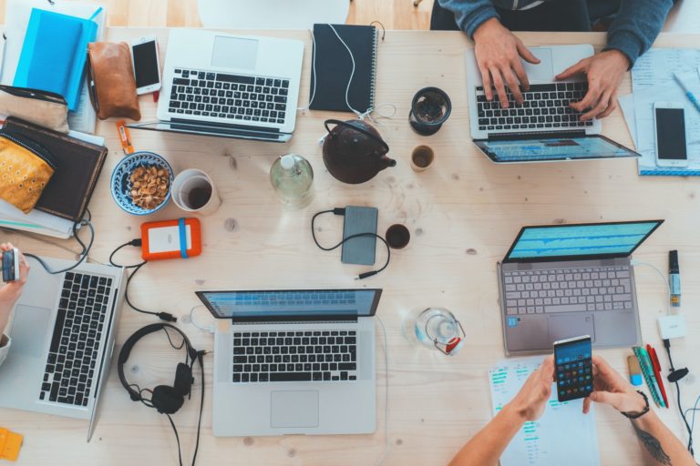 a table with many laptops and a keyboard