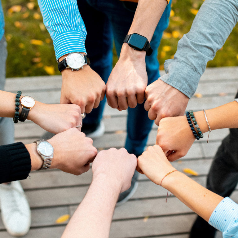 a group of people holding hands