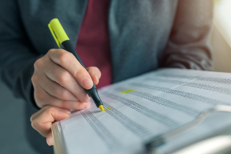 a person writing on a piece of paper