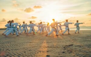 a group of people dancing on a beach