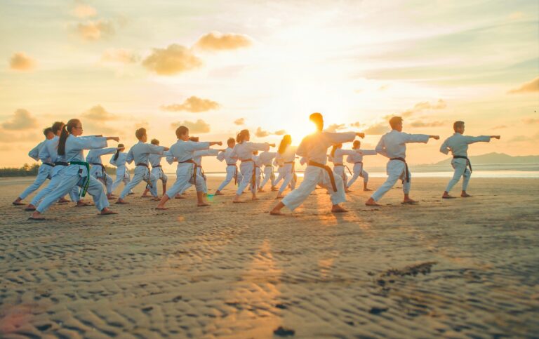a group of people dancing on a beach