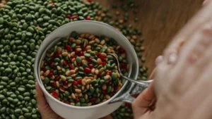 a person holding a bowl of mixed beans.